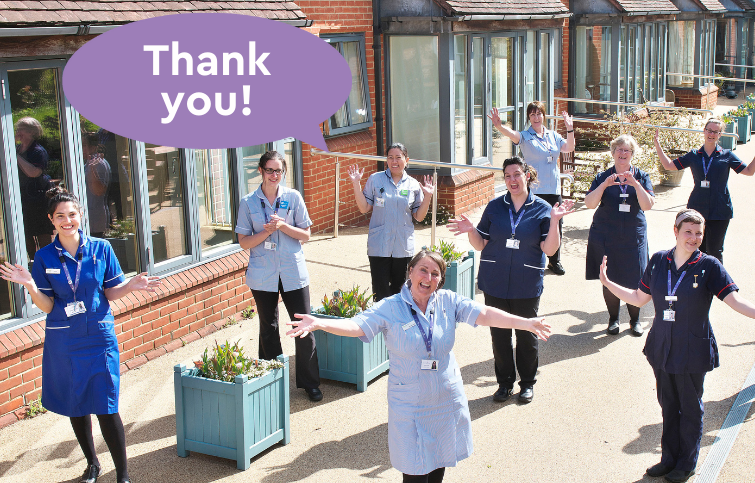 A group of nurses in the hospice garden saying thank you
