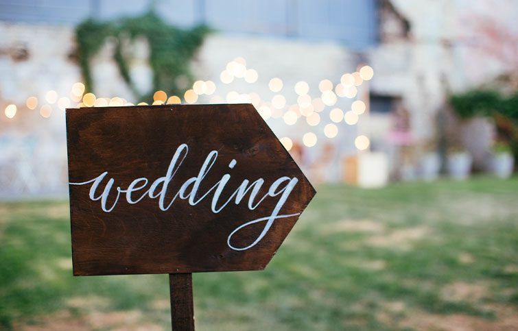 Wooden signed with the word wedding painted on