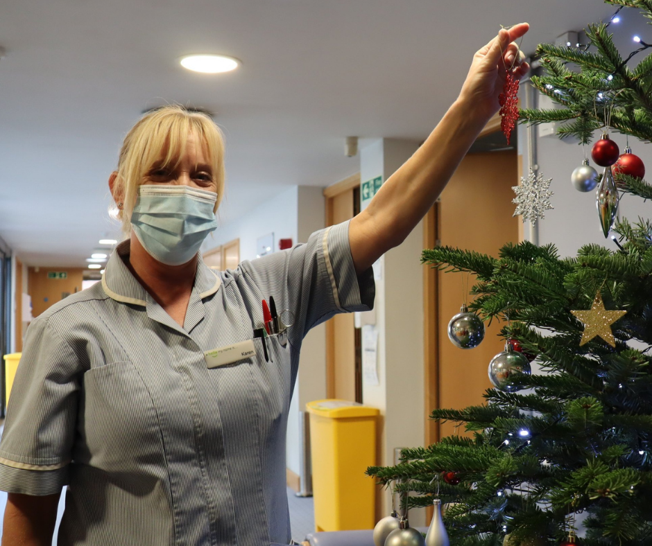 Karen Fulcher hanging an ornament on the Christmas tree