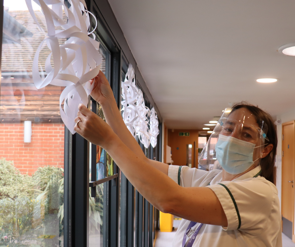 Bridget Russell hanging Christmas decorations in the inpatient unit