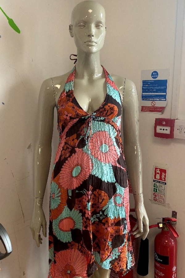 Mannequin dressed in a colourful patterned summer dress